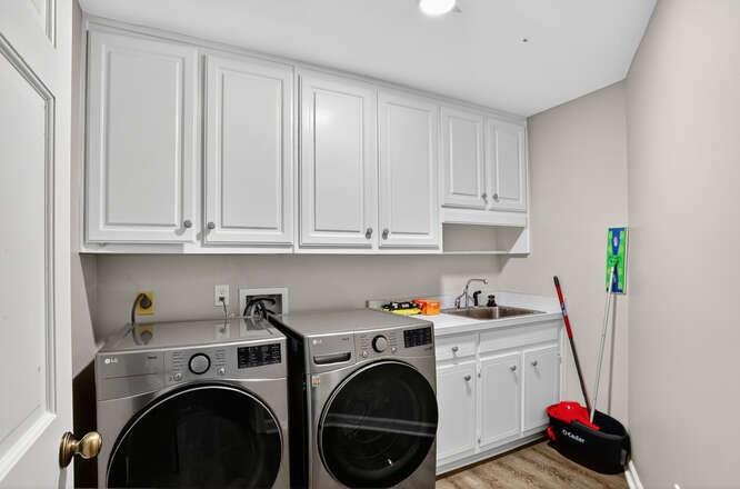 2551 East Maddox Road Buford, GA 30519 - Photo 37 of 50 a utility room with sink dryer and washer