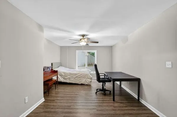 a bedroom with furniture and a wooden floor