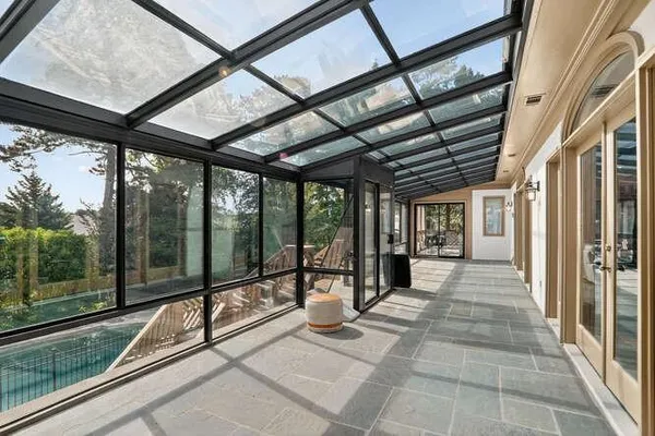 a view of a porch with a black gate