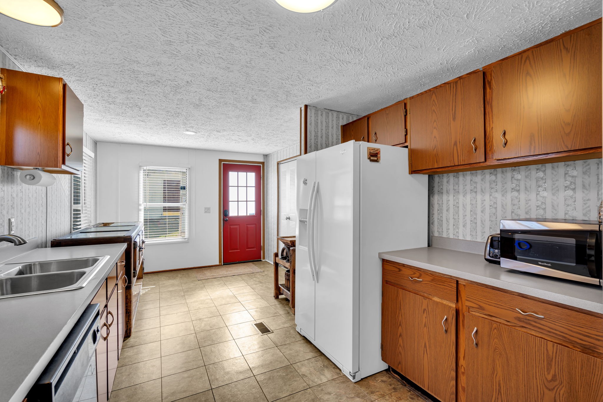 1039 Riverview Road Mount Juliet, TN 37122 - Photo 16 of 40 a kitchen with granite countertop a refrigerator stove and sink