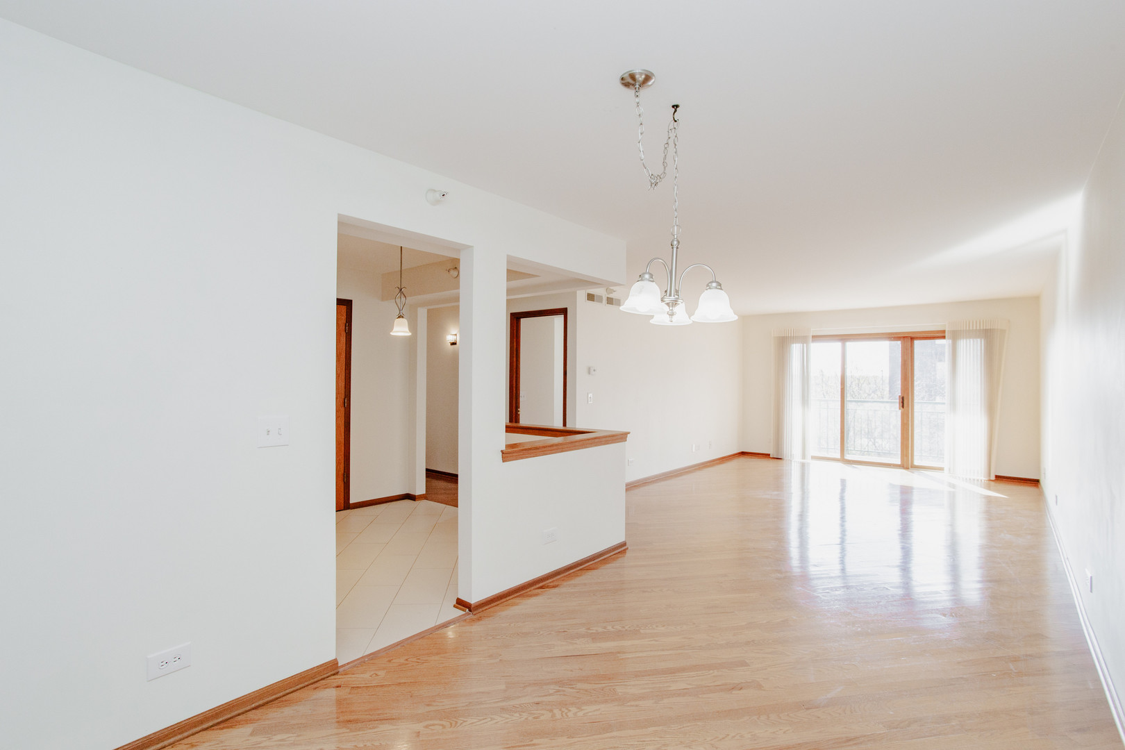 1685 Mill Street, Unit 605 Des Plaines, IL 60016 - Photo 12 of 25 a view of an empty room with window and wooden floor