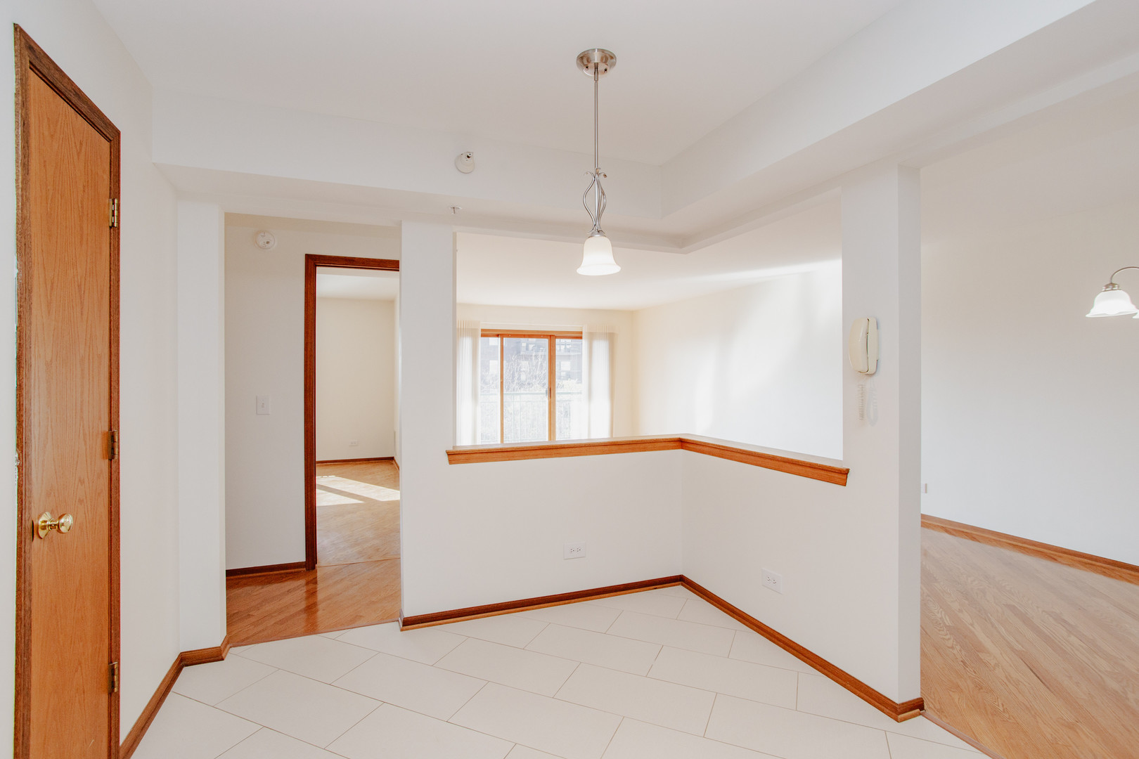 1685 Mill Street, Unit 605 Des Plaines, IL 60016 - Photo 8 of 25 a view of an empty room with window and wooden floor