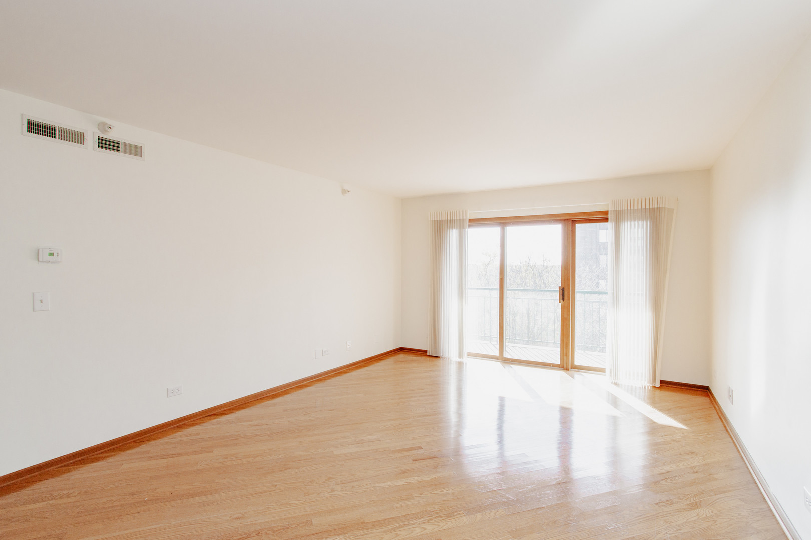 1685 Mill Street, Unit 605 Des Plaines, IL 60016 - Photo 9 of 25 a view of an empty room with wooden floor and a window