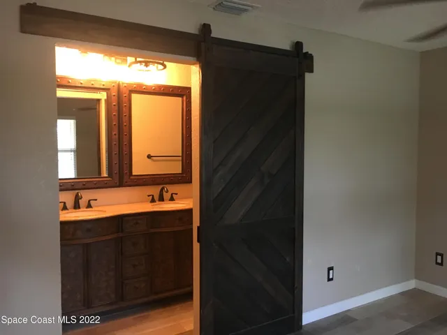 a bathroom with a double vanity sink and mirror
