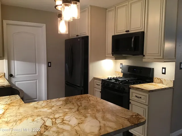 a kitchen with a stove and a refrigerator