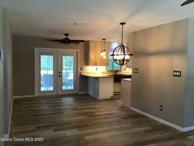 a view of a room with a sink and chandelier