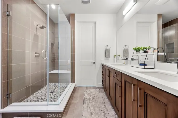 a bathroom with a double vanity sink a and a shower