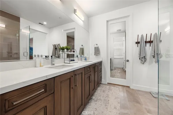a bathroom with a double vanity sink a and a mirror