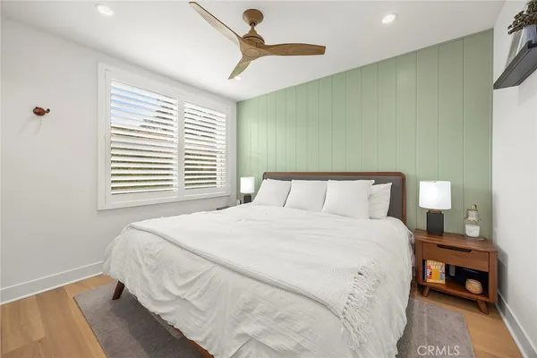 a bedroom with a bed and a night stand