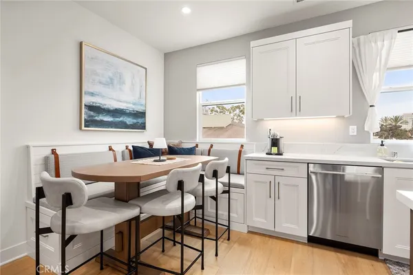 a white kitchen with a sink and cabinets
