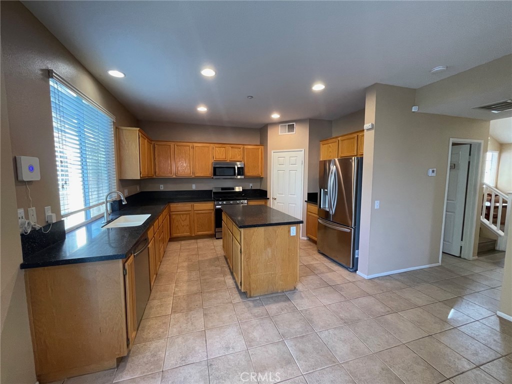 1434 Haddington Drive Riverside, CA 92507 - Photo 11 of 40 a kitchen with stainless steel appliances granite countertop a refrigerator a stove a sink and a microwave
