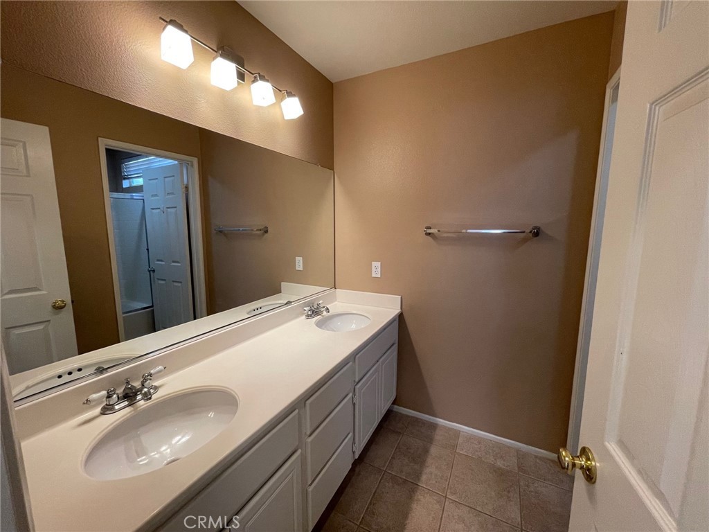 1434 Haddington Drive Riverside, CA 92507 - Photo 37 of 40 a spacious bathroom with a double vanity sink and mirror