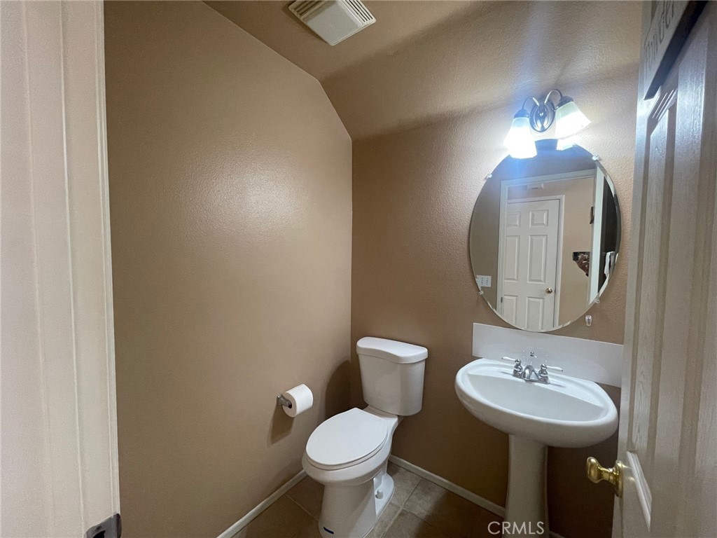 1434 Haddington Drive Riverside, CA 92507 - Photo 8 of 40 a bathroom with a toilet sink and mirror