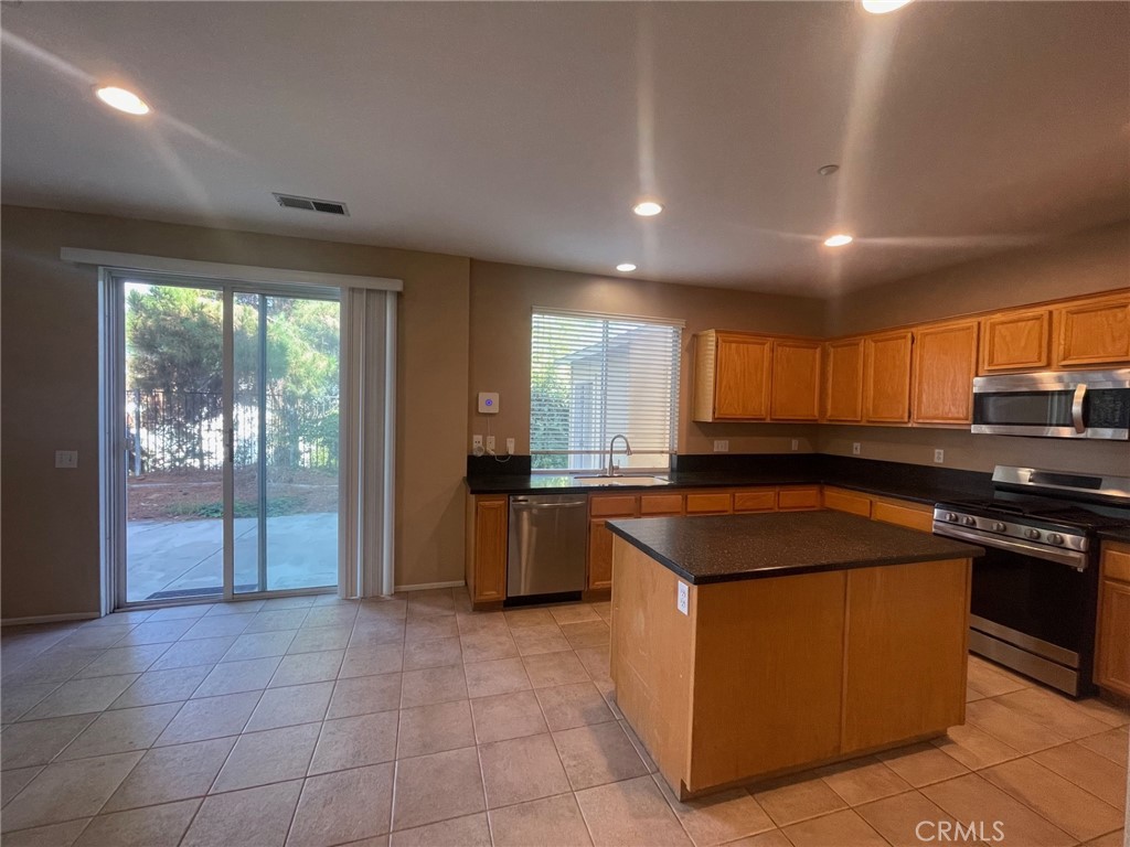 1434 Haddington Drive Riverside, CA 92507 - Photo 9 of 40 a kitchen with a stove a sink a counter top space and cabinets