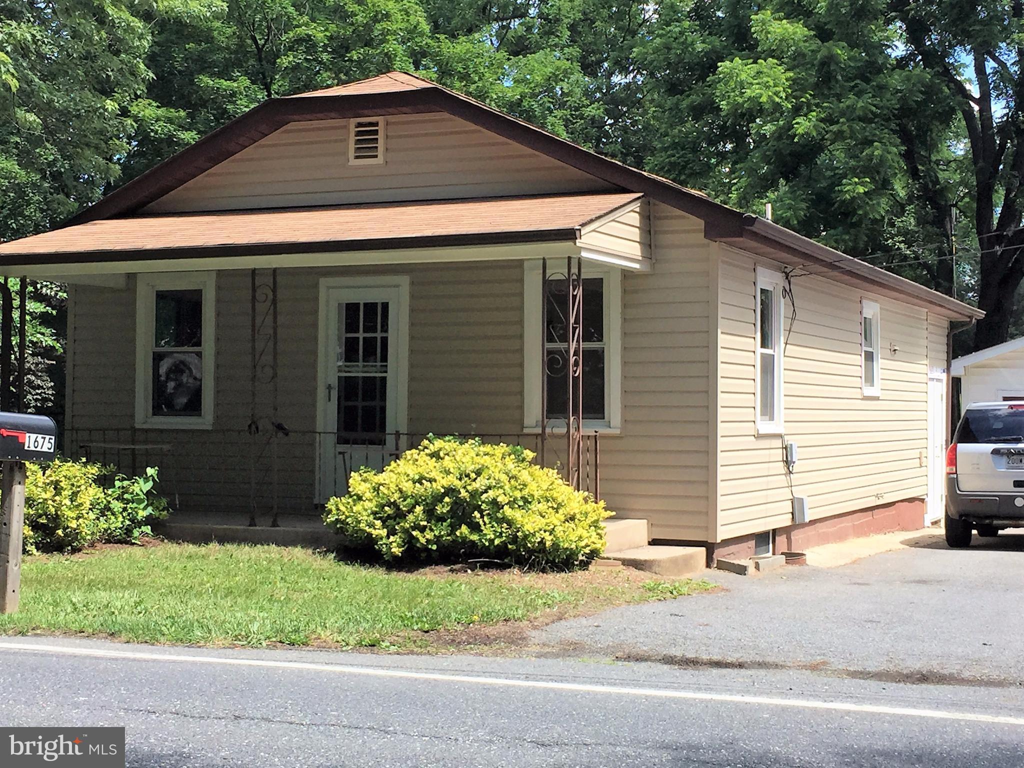 1675 Shookstown Road Frederick, MD 21702 - Photo 1 of 19 a front view of a house with a yard