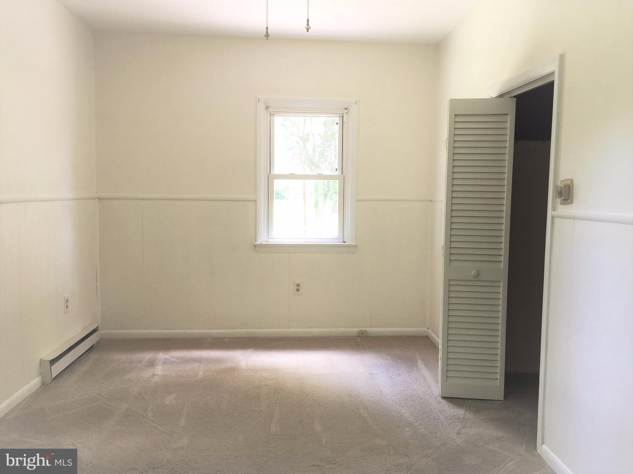 1675 Shookstown Road Frederick, MD 21702 - Photo 18 of 19 an empty room with a white cabinet and a window