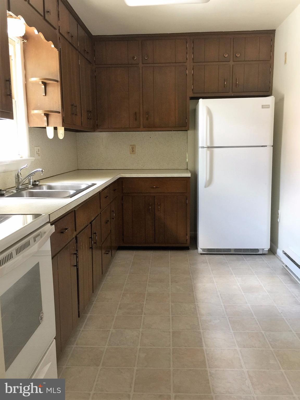 1675 Shookstown Road Frederick, MD 21702 - Photo 7 of 19 a kitchen with a refrigerator and a sink