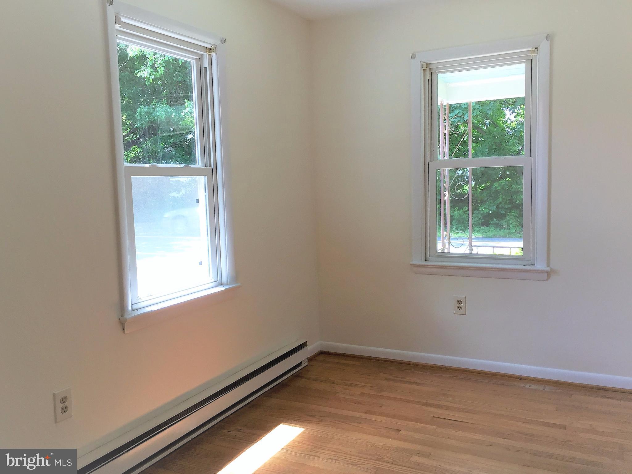 1675 Shookstown Road Frederick, MD 21702 - Photo 10 of 19 a view of an empty room with wooden floor and a window
