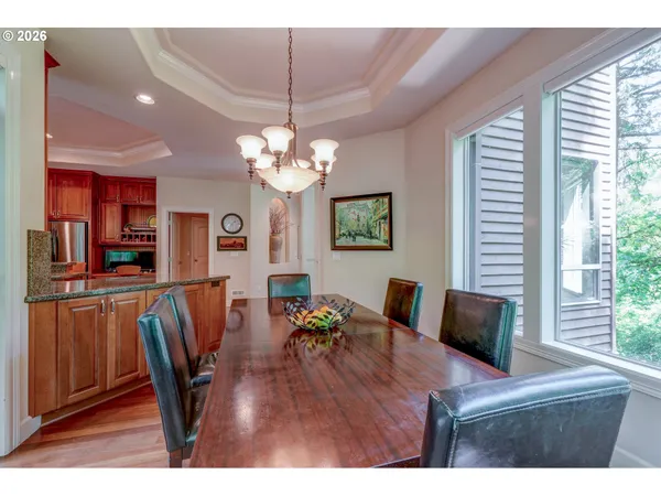 a view of a dining room with furniture a chandelier and wooden floor