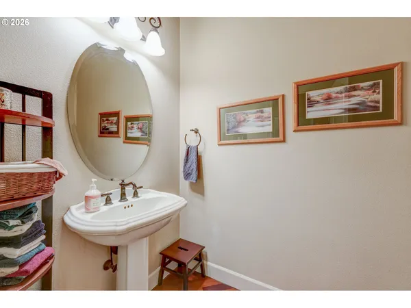a bathroom with a sink a mirror and a painting