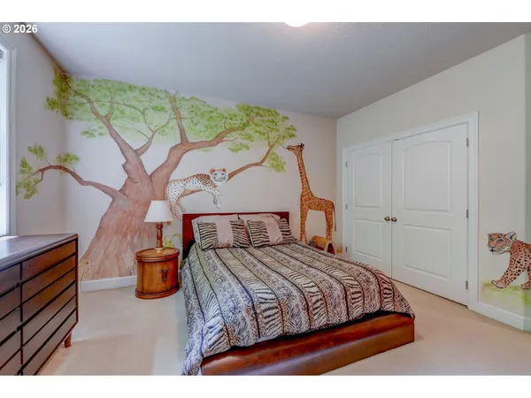 a bedroom with a bed and a painting on the wall