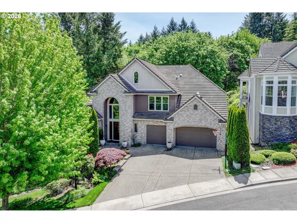 a front view of a house with a garden and plants