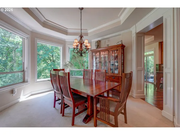 a dining room with furniture a chandelier and wooden floor