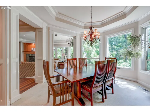 a dining room with furniture wooden floor and a chandelier