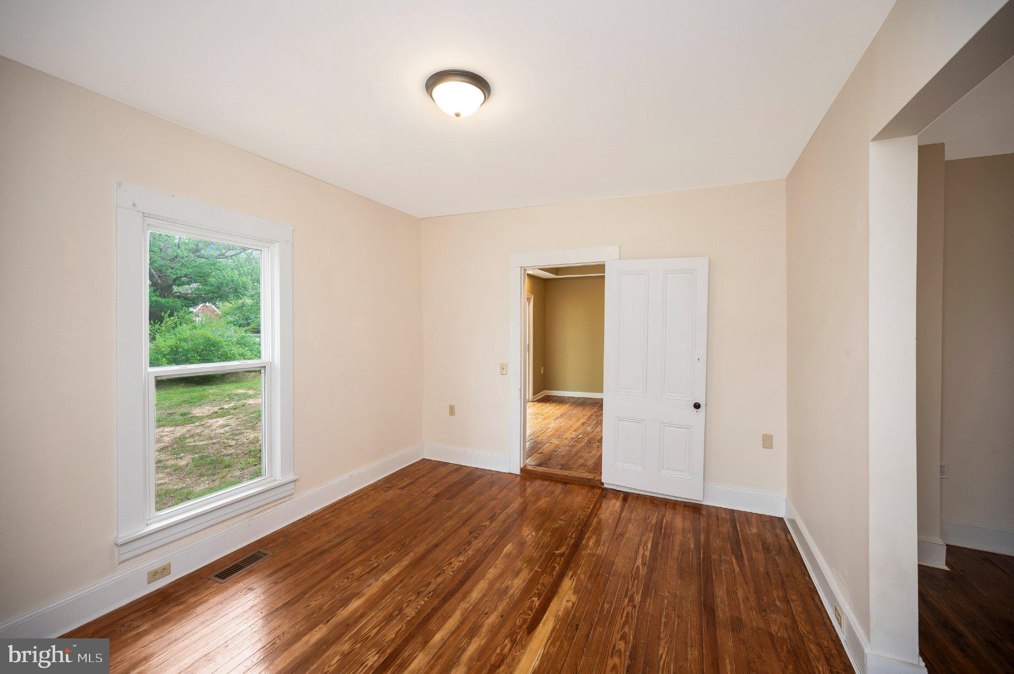 23202 Village Road Unionville, VA 22567 - Photo 13 of 58 a view of a room with wooden floor and window