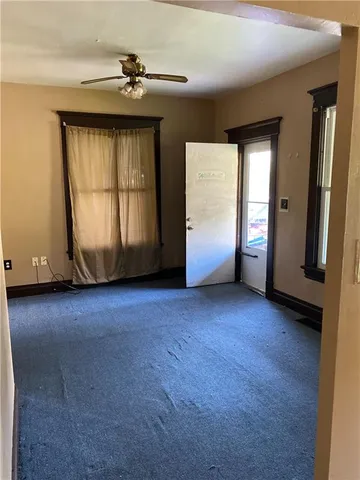 an empty room with windows and closet