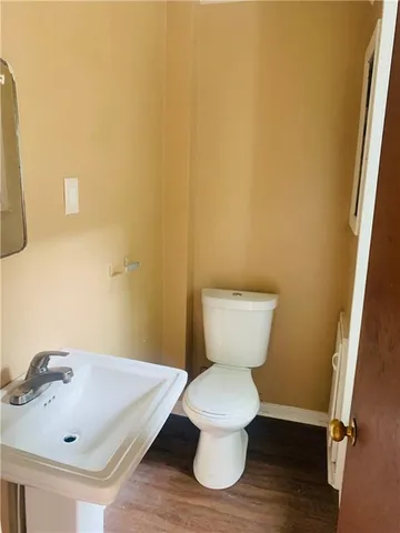 a white toilet sitting next to a bathroom sink