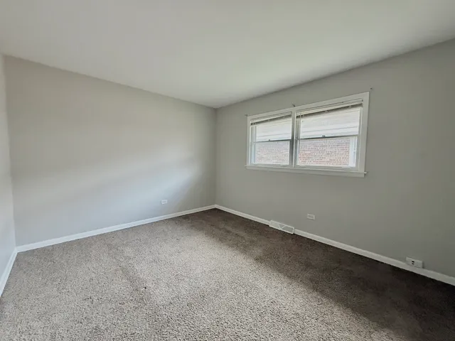 a bathroom with a toilet sink vanity and mirror