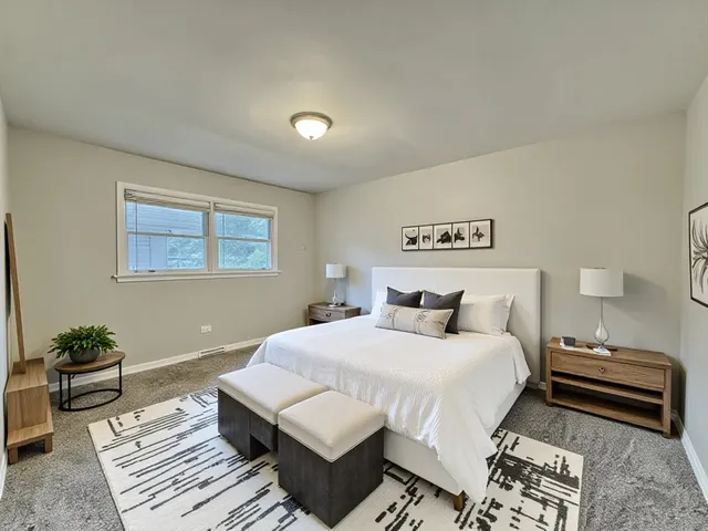 a bedroom with a bed and a potted plant