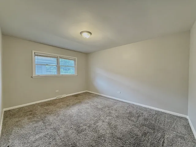 an empty room with a empty space and windows