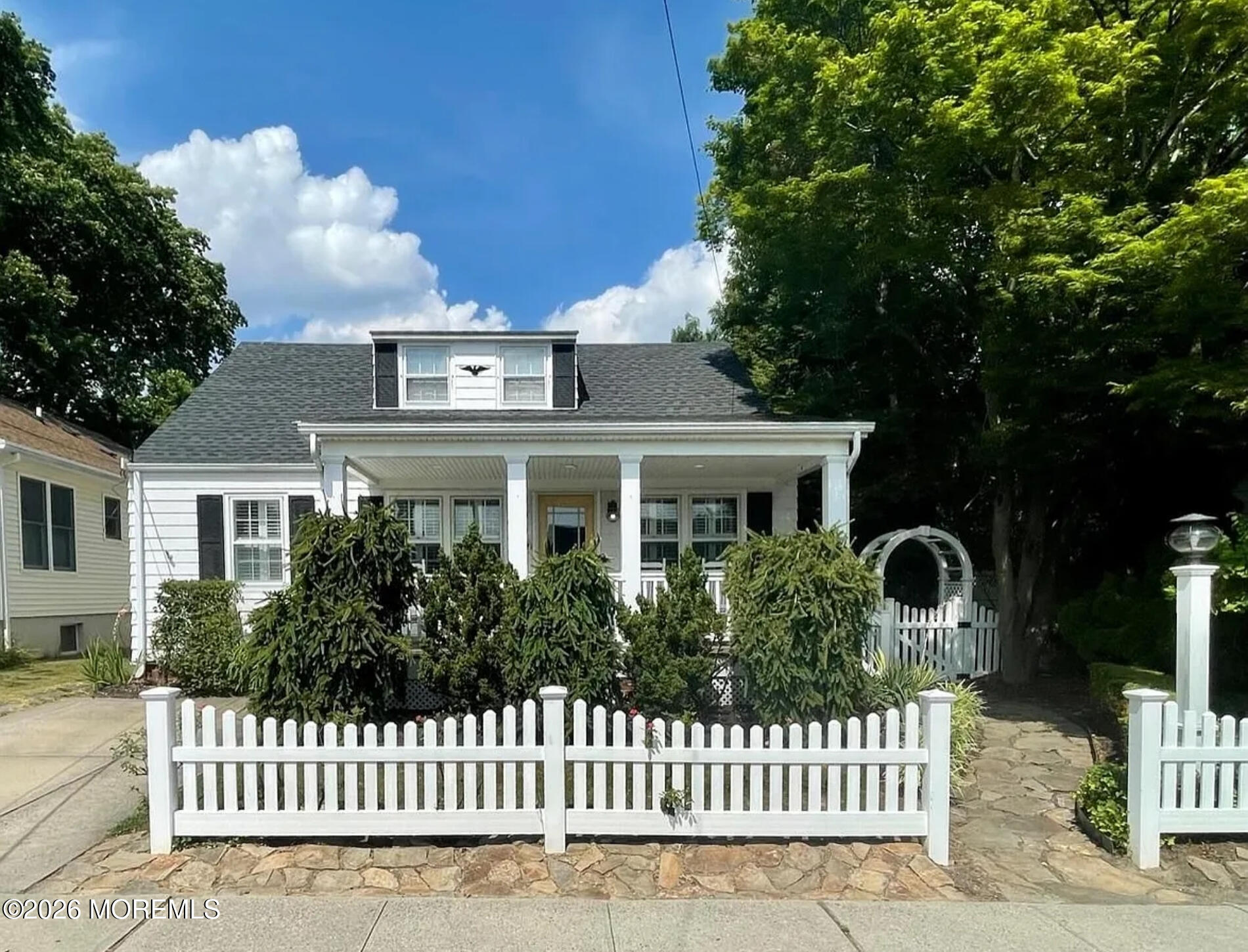 a front view of a house with a garden
