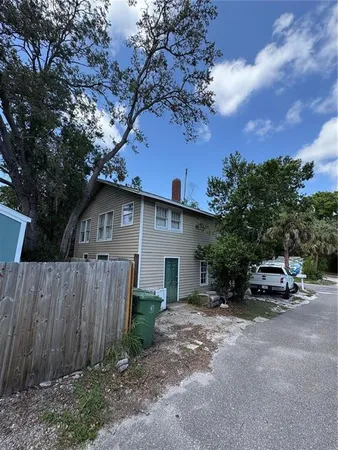 a view of house with outdoor space and car parked