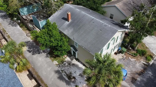 an aerial view of a house with a yard