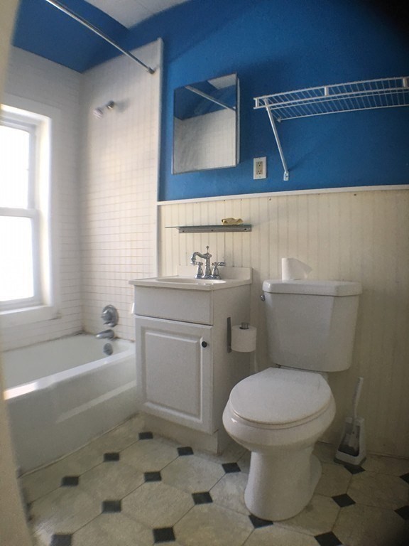 a bathroom with a toilet a sink and bathtub