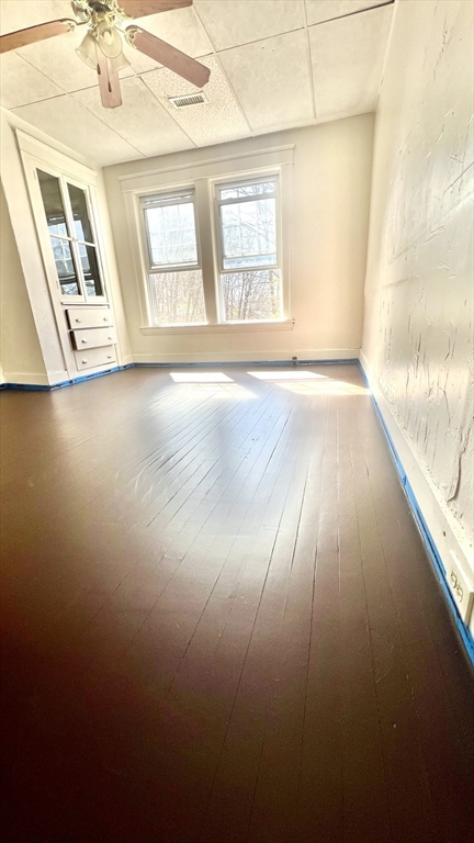 23 Firglade Street, Unit 3 Worcester, MA 01602 - Photo 2 of 12 an empty room with wooden floor and windows