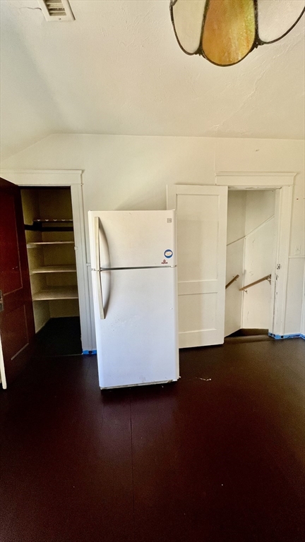 23 Firglade Street, Unit 3 Worcester, MA 01602 - Photo 5 of 12 a view of an empty room with wooden floor and cabinets