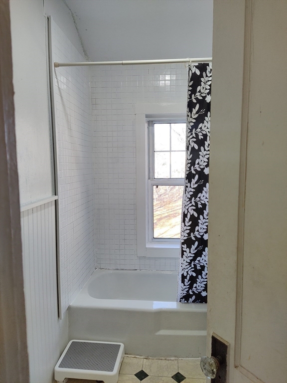 23 Firglade Street, Unit 3 Worcester, MA 01602 - Photo 10 of 12 a bathroom with a bathtub a shower and a window