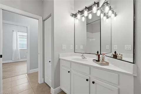 a bathroom with a double vanity sink and a mirror