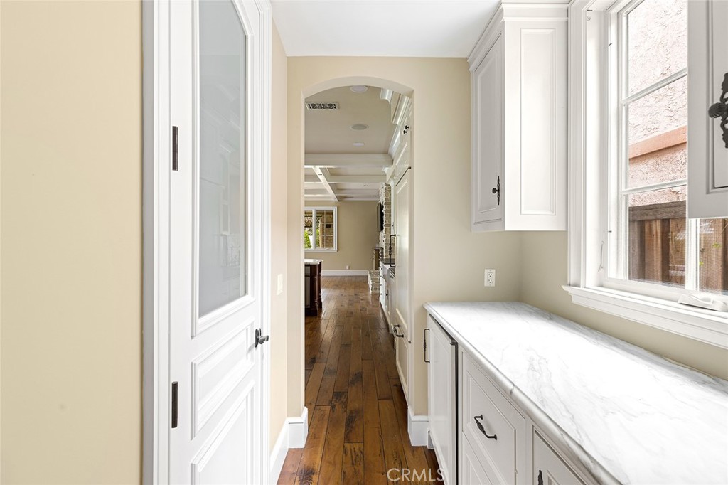 307 Pirate Road Newport Beach, CA 92663 - Photo 12 of 29 a hallway with cabinets and wooden floor