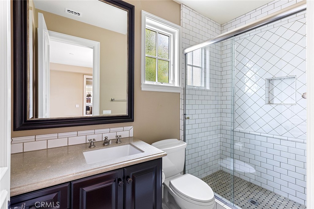 307 Pirate Road Newport Beach, CA 92663 - Photo 16 of 29 a bathroom with a sink a toilet and mirror