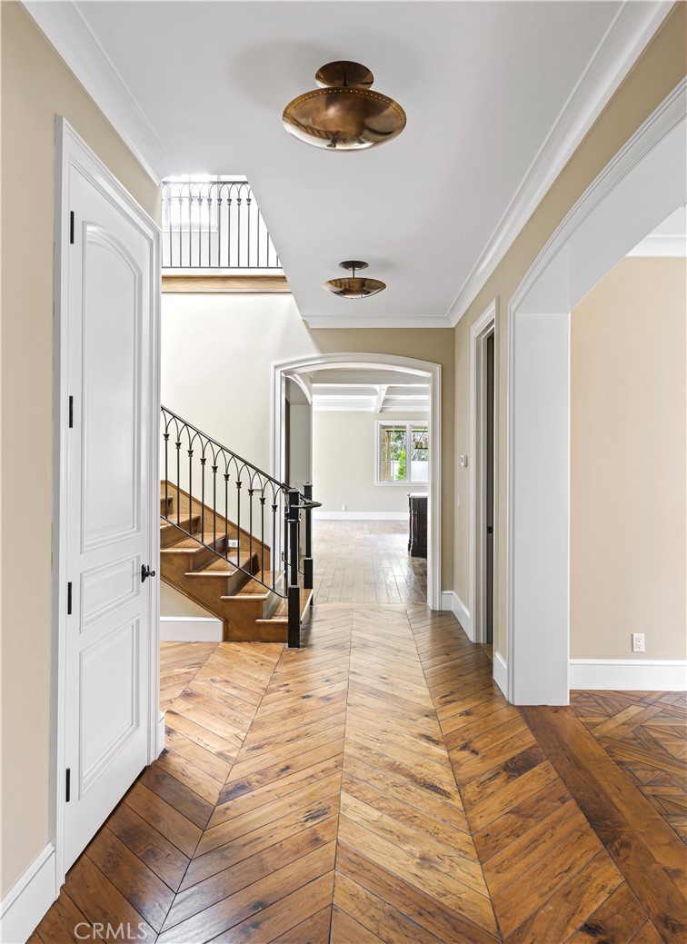 307 Pirate Road Newport Beach, CA 92663 - Photo 2 of 29 a view of a hallway to a livingroom with wooden floor and a ceiling fan