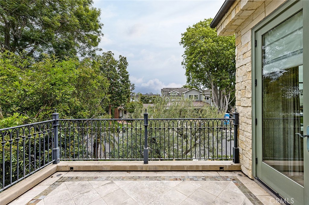 307 Pirate Road Newport Beach, CA 92663 - Photo 22 of 29 a view of a balcony with a floor to ceiling window and wooden fence