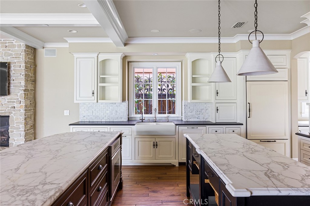 307 Pirate Road Newport Beach, CA 92663 - Photo 4 of 29 a kitchen with a stove a sink and a refrigerator