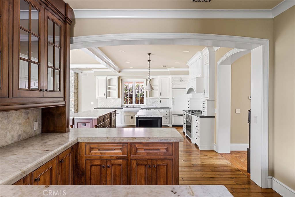307 Pirate Road Newport Beach, CA 92663 - Photo 5 of 29 a kitchen with stainless steel appliances kitchen island granite countertop a sink and wooden cabinets