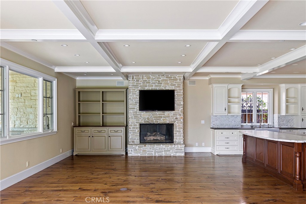 307 Pirate Road Newport Beach, CA 92663 - Photo 6 of 29 a living room with stainless steel appliances kitchen island granite countertop a fireplace and a flat screen tv