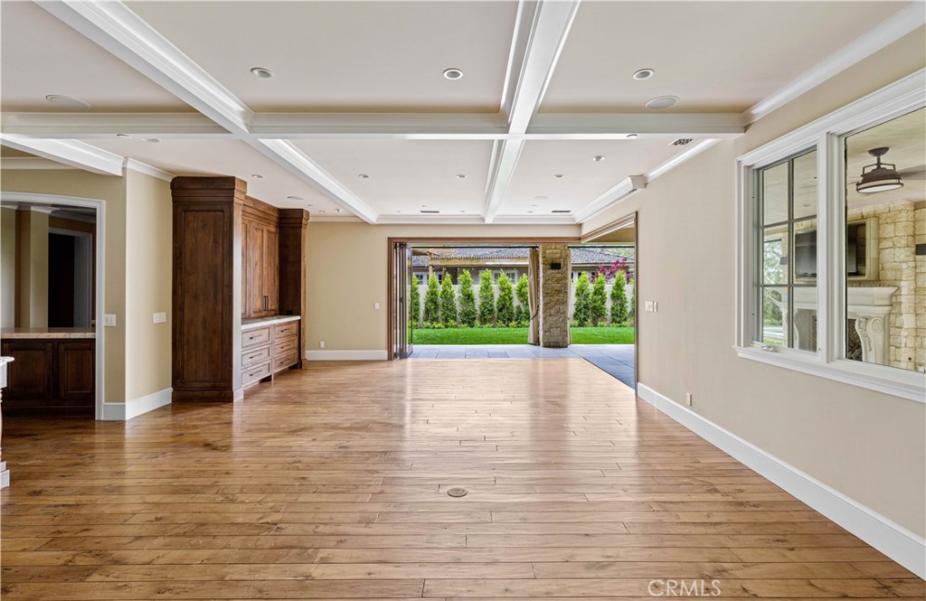 307 Pirate Road Newport Beach, CA 92663 - Photo 7 of 29 a view of an empty room with a window and wooden floor